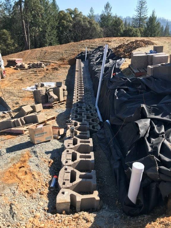 Long rebar retaining wall foundation trench with pump truck